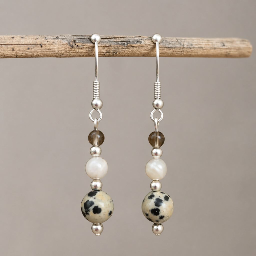Calm and Clear Earrings with smoky quartz, moonstone, and dalmatian jasper gemstones on silver hook.