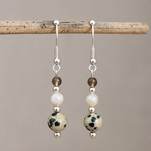 Calm and Clear Earrings with smoky quartz, moonstone, and dalmatian jasper gemstones on silver hook.