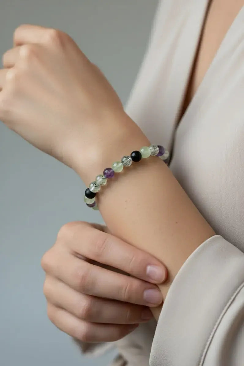 Close-up of a wrist wearing a gentle boundaries beaded bracelet with a neutral background.