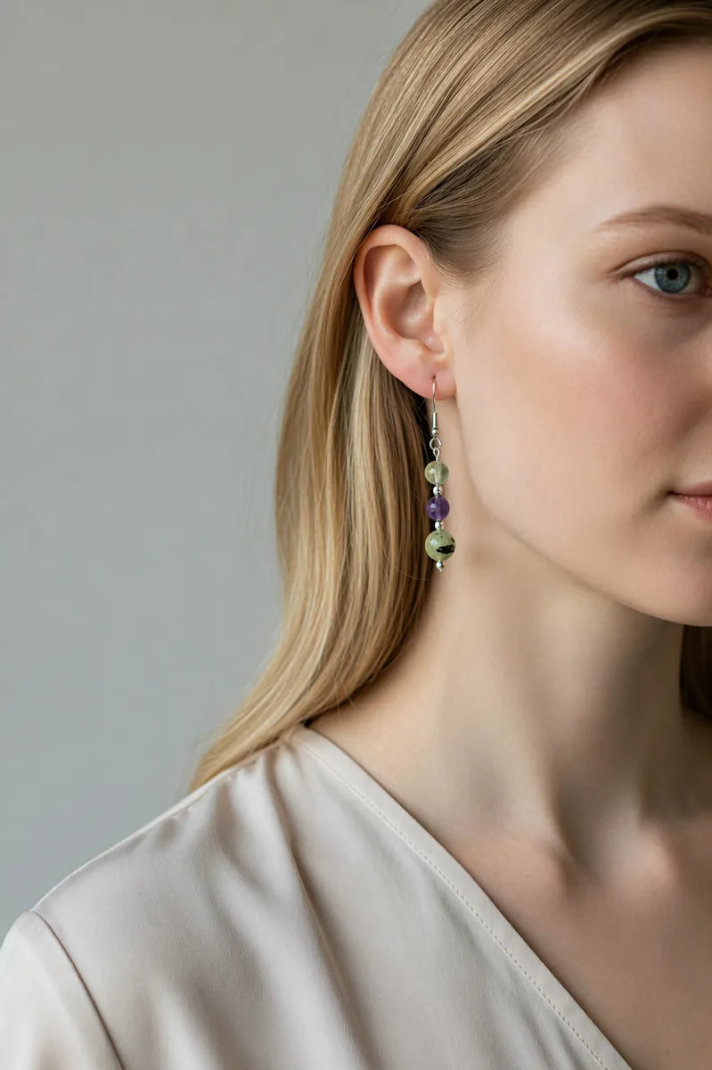Close-up of a woman wearing gentle boundaries earrings with a neutral background.