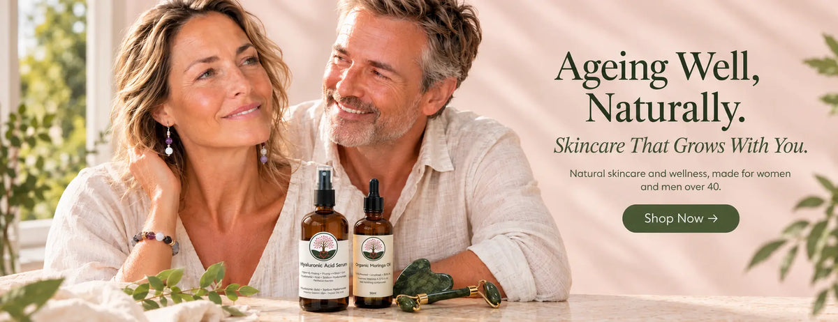 Luv Your Age brand banner: a smiling middle-aged woman and man sitting together at a table with Hyaluronic Acid Serum and Organic Moringa Oil bottles and jade facial tools. Text reads "Ageing Well, Naturally. Skincare That Grows With You. Natural skincare and wellness, made for women and men over 40." Shop Now button.
